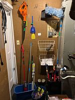 Overall view of leaf blower, handled tools in bins, wall baskets