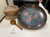 Cloisonné bowl, painted wooden ladle on table