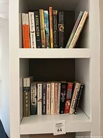 Two shelves of assorted fiction books