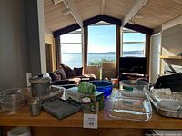 overall lot view showing glass dishes, bowls, pot, supplies on counter