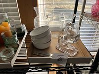 Group shot of entire lot on shelf showing vases, bowls, horse figurine, one spreader