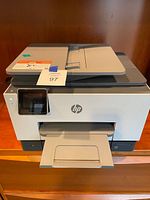 Front view of HP OfficeJet Pro 9025e printer with touchscreen and output tray extended