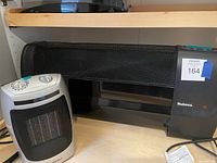 Holmes horizontal heater next to Sylvania compact heater showing full view