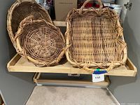 All three wicker baskets on shelf, showing shapes and size comparison