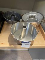 Three tube cake pans on shelf