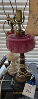 Pressed cranberry glass font lamp on turned wood column