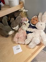 Group view showing all seven stuffed toys on shelf