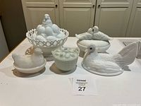 Group shot of five milk glass covered dishes on counter