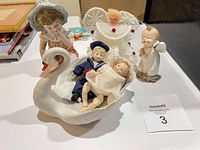 Group shot of all six pieces including swan planter, dolls, figurines, crochet angel
