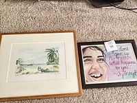 Both framed artworks side by side on carpet