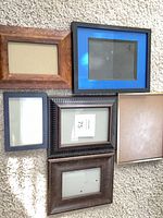 Six assorted frames laid on carpet