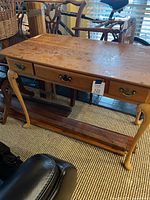 Full view of desk showing top surface, drawers and stretcher shelf