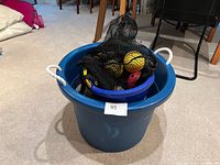 Overall lot in large blue tub with mesh bag visible