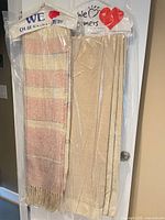 Throw and folded curtain panels hanging in plastic covers