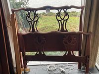 Headboard and footboard leaning against window