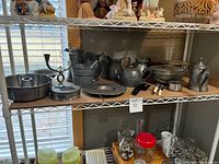 Full lot on shelf showing all pewter and metal items