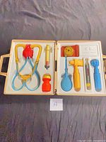 Open case showing all toy instruments arranged in molded insert