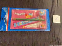 Front view of sealed Popples school kit showing all included items