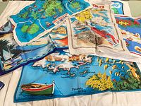 All six tea towels laid out showing various printed designs