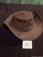 Front angled view of leather outback hat showing shape and brim