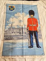 Full view of tea towel showing guardsman illustration and crest