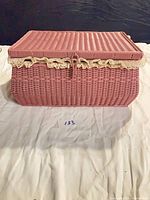 Closed pink wicker-look sewing basket front view