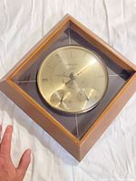 Full view of square wood-framed Airguide weather station