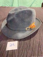 Front view of grey Stetson fedora with feather and buckle band