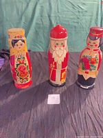 Three painted wooden vodka bottle boxes front view