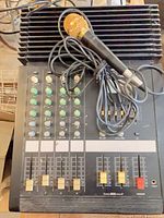 Full view of mixer top with microphone placed on faders