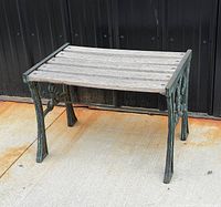 Full view of bench showing cast-iron sides and wood slats