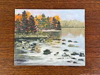 Full view of oil painting on wood grain background