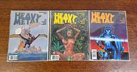 Three bagged Heavy Metal magazines front covers
