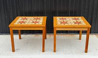 Front view of both teak tile-top tables