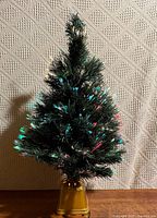 Full view of 2.5' fibre-optic Christmas tree on gold plastic stand
