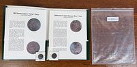 Overview showing both information sheets, both coins in holders, and clear bag