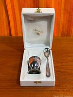 Cup and spoon in open Christofle box