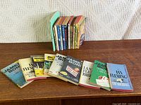 Entire lot showing Bond books laid out and additional titles stacked upright