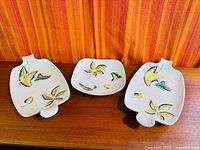 Three Shorter & Sons ceramic serving pieces on wood surface