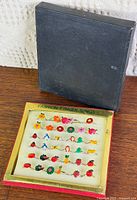 Closed black box and open display tray showing rings in foam insert