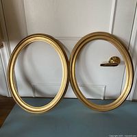 Both gold oval frames front view