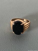 Front view of 10K gold signet ring with black stone