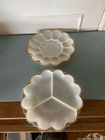 Both milk glass plates on surface showing overall design and size comparison