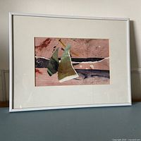 Full view of framed collage in white metal frame with mat