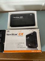 Front of NexStar CX enclosure on foam with box