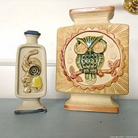 Front view of both vases showing owl and elephant motifs