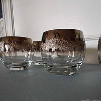 Side view showing three glasses highlighting ombre silver rims and textured band