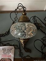 Pendant lamp, globe, chain and cord visible
