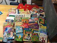 Wide view of stacked and spread children’s books on tabletop