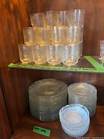 stacked tumblers and plates in cabinet